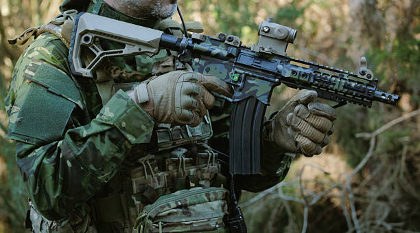 istock Soldier holding a rifle during a military operation in the forest 2218900657