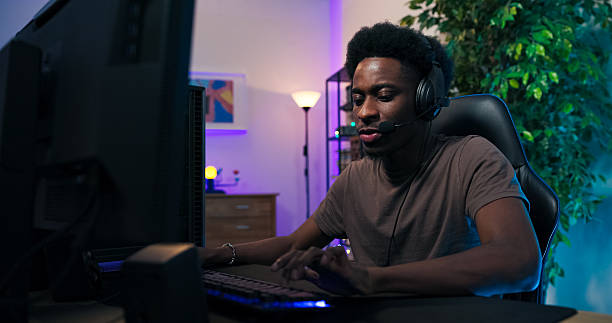istock A focused gamer talks to team through headset during online match, but after disqualification he hides his face in hands, processing frustration and sadness. 2218901592