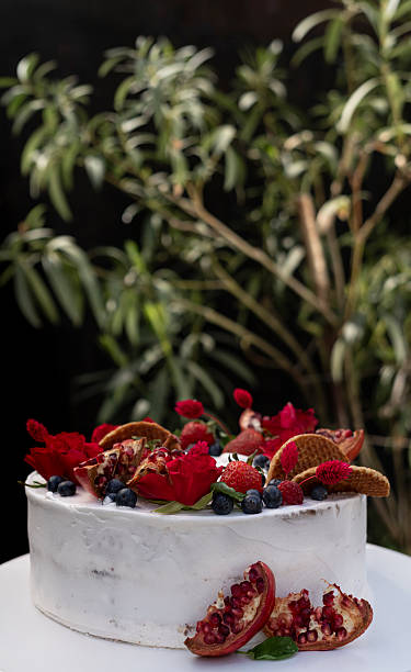 istock Small wedding cake decorated with fresh strawberries, pomegranate and flowers 2218902996