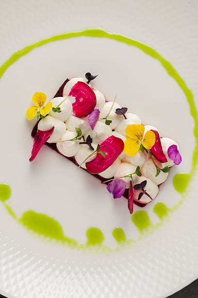 istock Colorful beetroot slices with goat cheese, garnished with edible flowers 2218905671