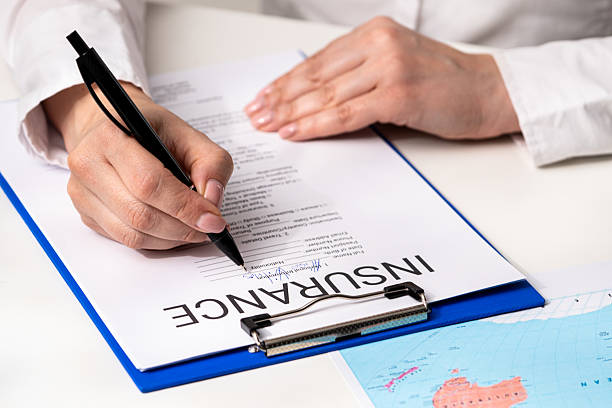 istock Signing Important Insurance Documents with Pen on Clipboard 2218914532