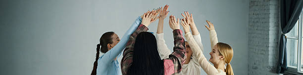 istock Women Celebrating by Clapping Hands Together in Circle 2218916087