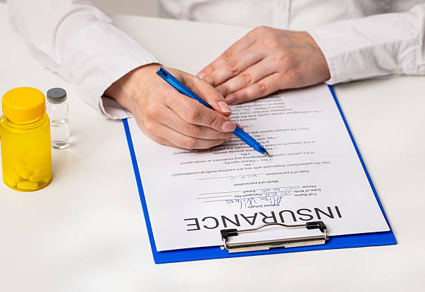 istock Filling Out Insurance Documents with Precision and Care 2218916194