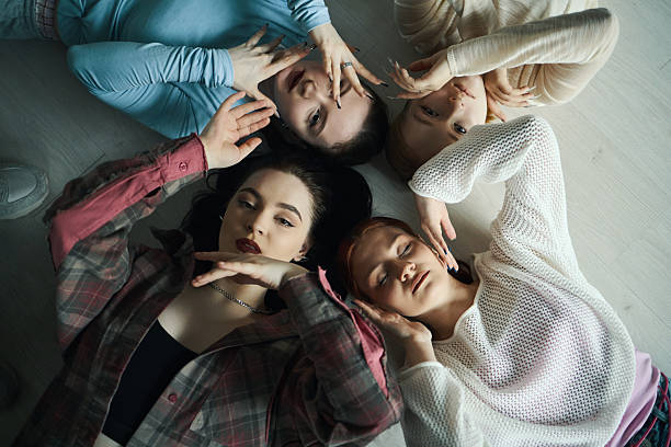istock Group of Friends Lying and Making Peace Signs On Floor 2218916617