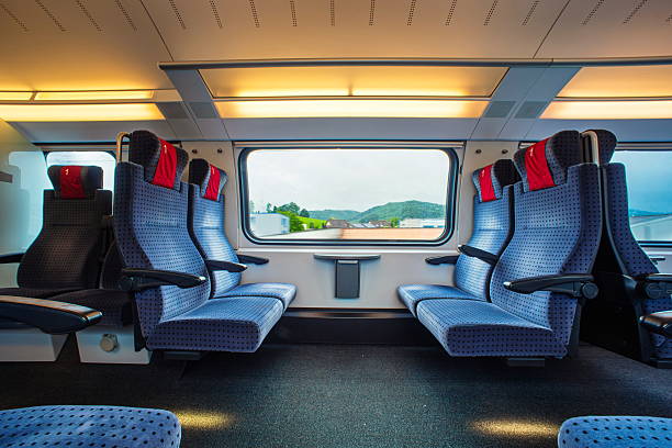istock Blue empty opposing, first class seats in a moving train. Large window, daytime, summer, no people. 2218918779