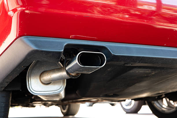 istock Single tip car exhaust pipe or tail pipe. Low angle view, chromed metal, no people 2218918794