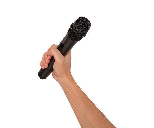 istock Hand holding wireless microphone isolated on white background. Premium high quality studio shot. Concept for entertainment and recreation. 2218924364