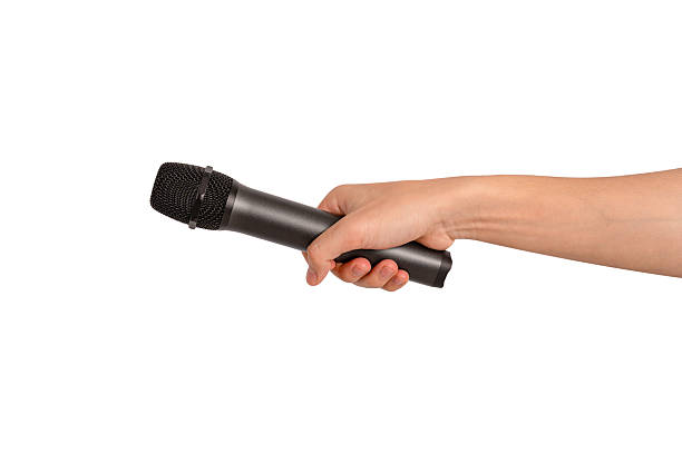 istock Hand holding wireless microphone isolated on white background. Premium high quality studio shot. Concept for entertainment and recreation. 2218924377