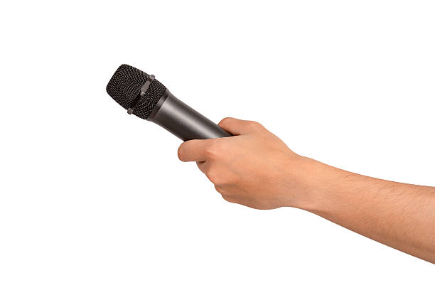 istock Hand holding wireless microphone isolated on white background. Premium high quality studio shot. Concept for entertainment and recreation. 2218924389