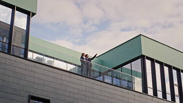 istock Business colleagues talking balcony office building. Partners discussing work 2218925462