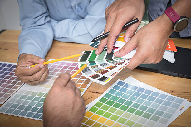 istock Interior designer chooses a color chart for home design. Graphic designers working on color chart at modern office. 2218926516