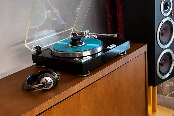 istock Vintage Stereo Turntable Record Player With Blue Colored Disk, Headphones and Silver Weight Clamp, Wooden Console Cadenza, Black Loudspeaker 2218929046