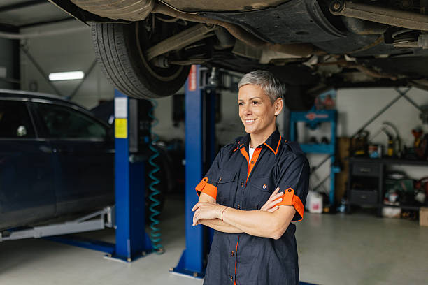 istock Mechanic with Arms Crossed Smiling in Workshop 2218929258