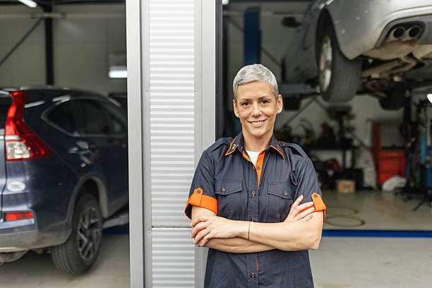 istock Smiling Mechanic Poses Confidently in Garage 2218929274