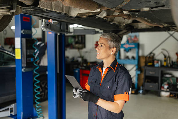 istock Woman Mechanic Inspects Vehicle Underneath Garage 2218929522