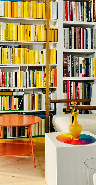 istock Library book shelves with a white comfortable armchair 2218933519