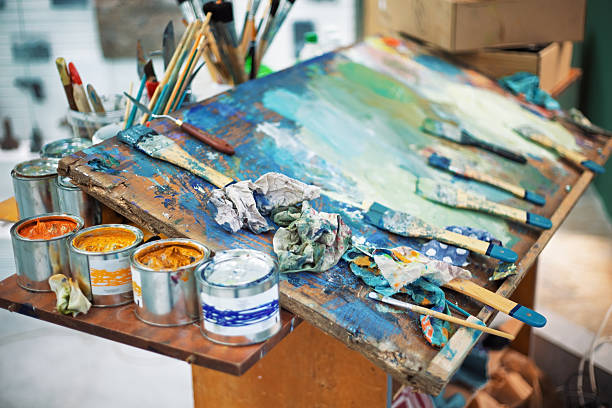 istock Artist is using paintbrushes and palette knives while painting on canvas 2218936351
