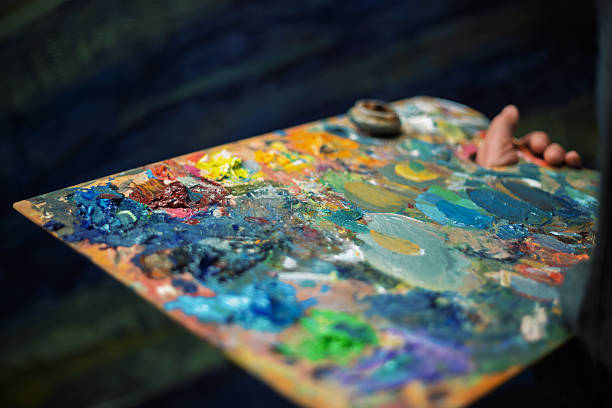 Artist holding a palette with colorful oil paints, ready to create a masterpiece