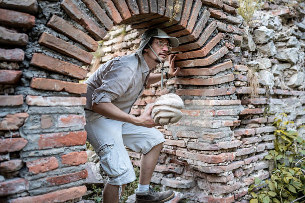 A curious explorer examining an ancient structure while holding an artifact, showcasing archaeology adventures. The setting features an aged brick arch surrounded by nature, exuding historical charm and discovery.