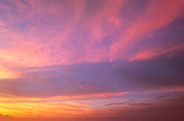 istock Colorful sunset sky with setting sun behind vivid orange and yellow clouds 2218940515