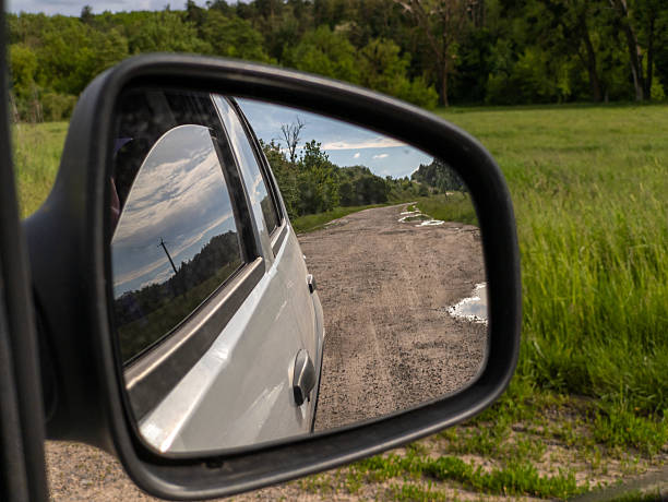istock A side view mirror of a car on a dirt road 2218945949
