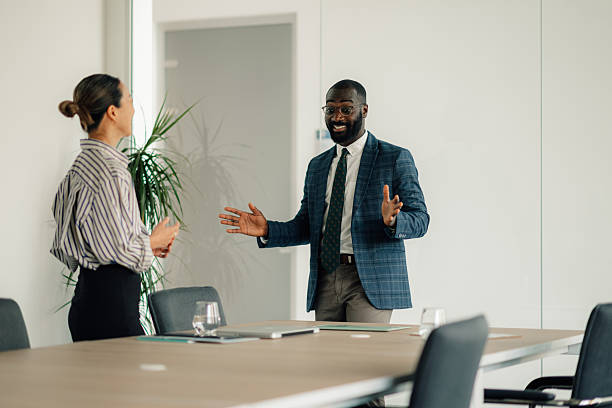 istock Enthusiastic businessman leading a meeting in a modern office 2218948000