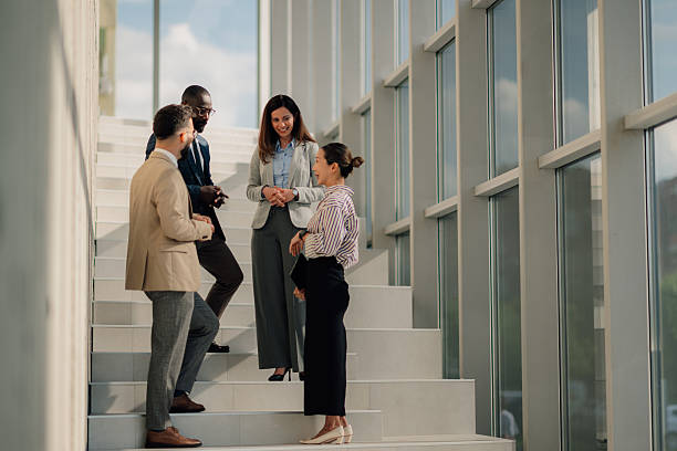 istock Business people talking on stairs in modern office 2218948562