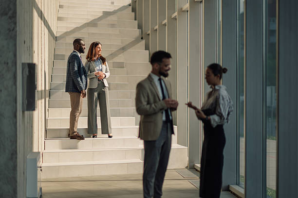 istock Business people talking in modern office building lobby 2218948564