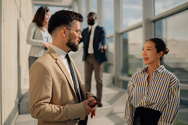 istock Businesspeople talking during a break in the office hall 2218948585