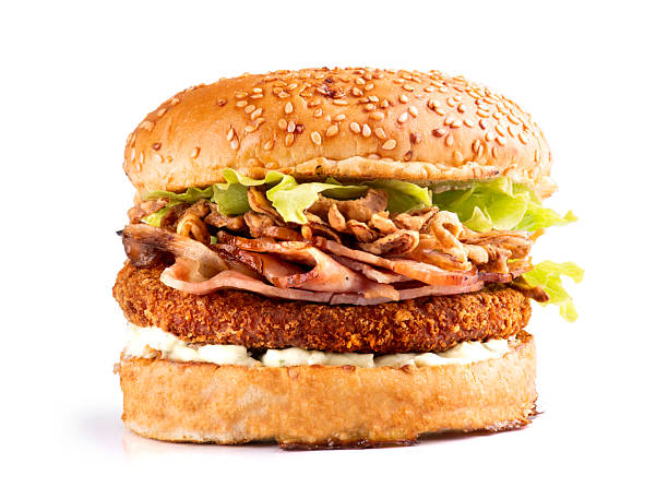 istock Crispy breaded fried chicken burger with lettuce, bacon and onion on a sesame seed bun 2218949551