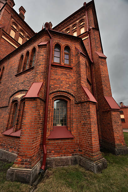 istock Catholic red brick church with a clock 2218951626