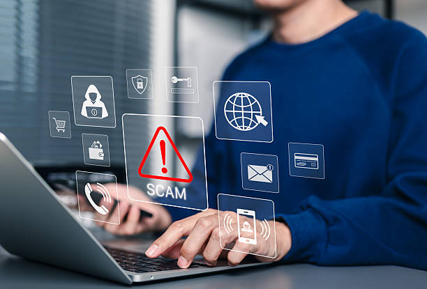 scam alert warning with cybersecurity icons. man holding smartphone while using laptop, warning sign for scams with icons online threats, phishing, cybersecurity, unknown person, suspicious scammer, - bedragare bildbanksfoton och bilder