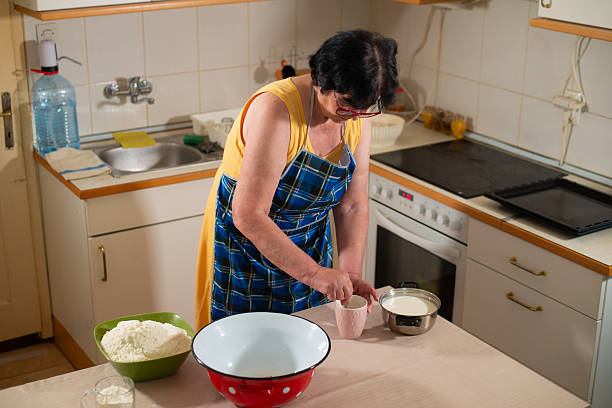 istock Grandmother makes cookies in the kitchen 2218954758