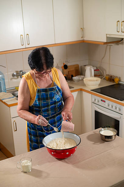 istock Grandmother makes cookies in the kitchen 2218954777
