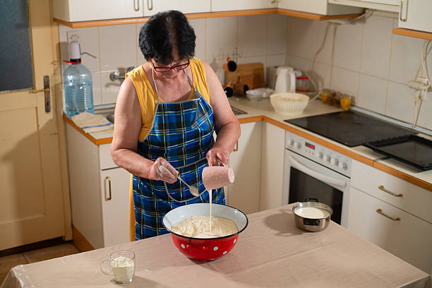 istock Grandmother makes cookies in the kitchen 2218954801