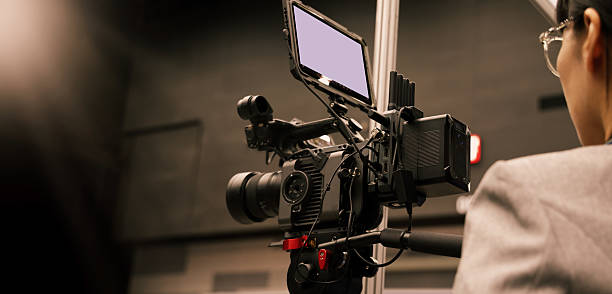 istock Professional cinema cameras being used in a studio or event setting.  High end gear with crew operation and behind the scenes video production in action. Camera for Live recording and broadcasting. 2218955988