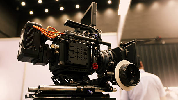 istock Professional cinema cameras being used in a studio or event setting.  High end gear with crew operation and behind the scenes video production in action. Camera for Live recording and broadcasting. 2218955989