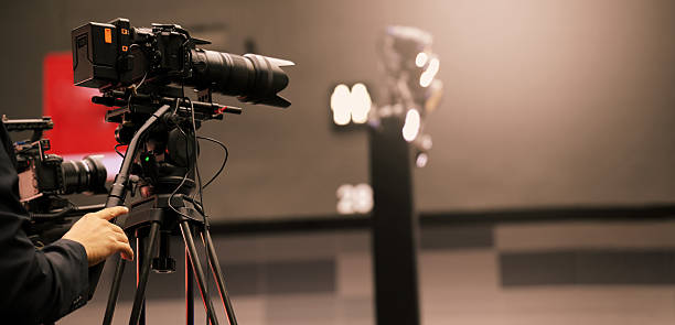 istock Professional cinema cameras being used in a studio or event setting.  High end gear with crew operation and behind the scenes video production in action. Camera for Live recording and broadcasting. 2218955991