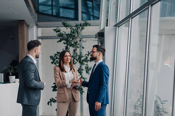 istock Business people discussing work in modern office building lobby 2218957716