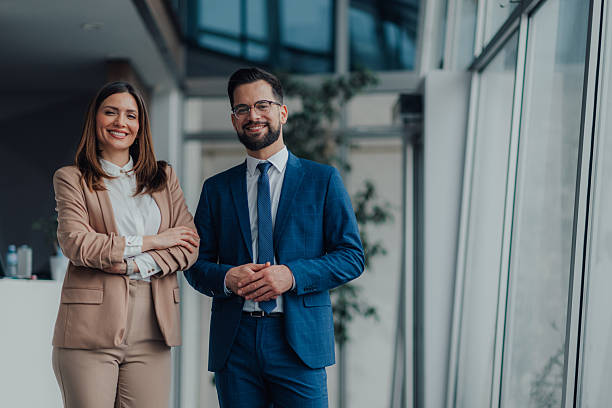 istock Smiling businesspeople posing in modern office building lobby 2218957814
