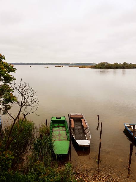 istock Rustic Rowboats Moored by a Lakeside on a Cloudy Morning 2218959505