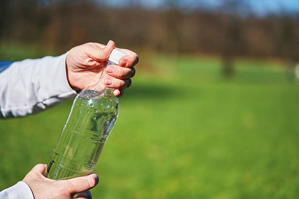 Drinking Water from Recycled PET Plastic Bottle Outside