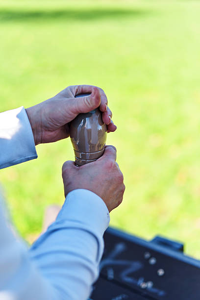 Close-up of man holding a 9 mm bullet.