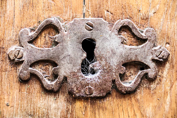Old and rusty lock with cobweb on a wooden door in Alcaraz town, Albacete, Spain