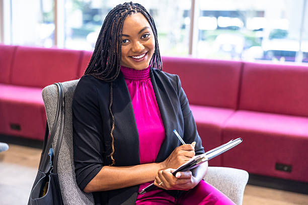 istock Young black businesswoman sitting and taking notes 2218963690