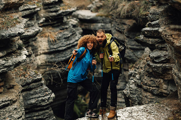 istock Hikers couple pointing while trekking in rocky canyon 2218965322