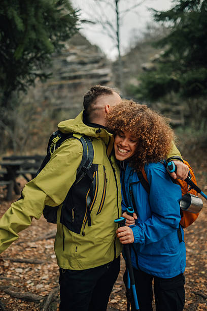 istock Hikers couple embracing while hiking in the woods 2218965331