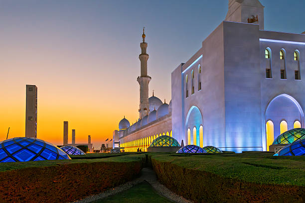 The Sheikh Zayed Grand Mosque, the largest mosque in the UAE, illuminated at twilight blue hour in Abu Dhabi, United Arab Emirates.