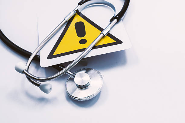 istock Stethoscope is placed on a yellow warning sign, symbolizing potential health risks and the importance of medical attention 2218965380