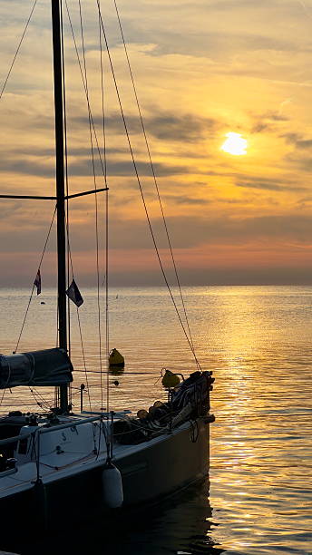 istock Sailboat Silhouette at Sunset on Tranquil Sea 2218965543